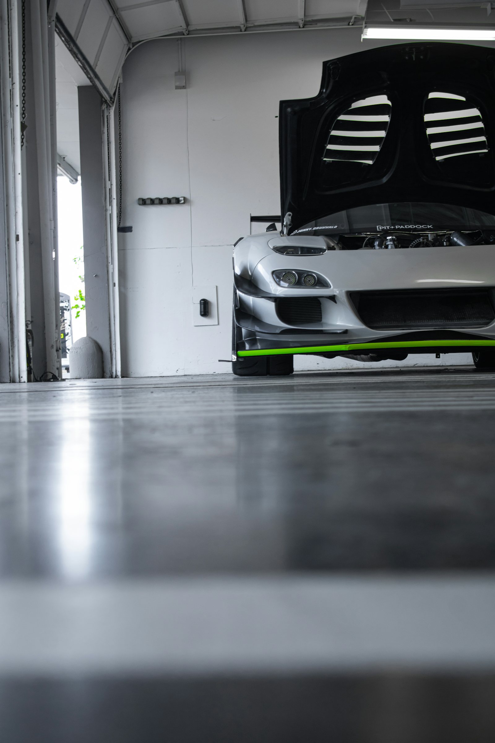 Glossy epoxy-coated garage floor in a clean residential garage in Ann Arbor, MI